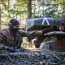 Soldaten auf einem Panzer navigieren durch den Wald
